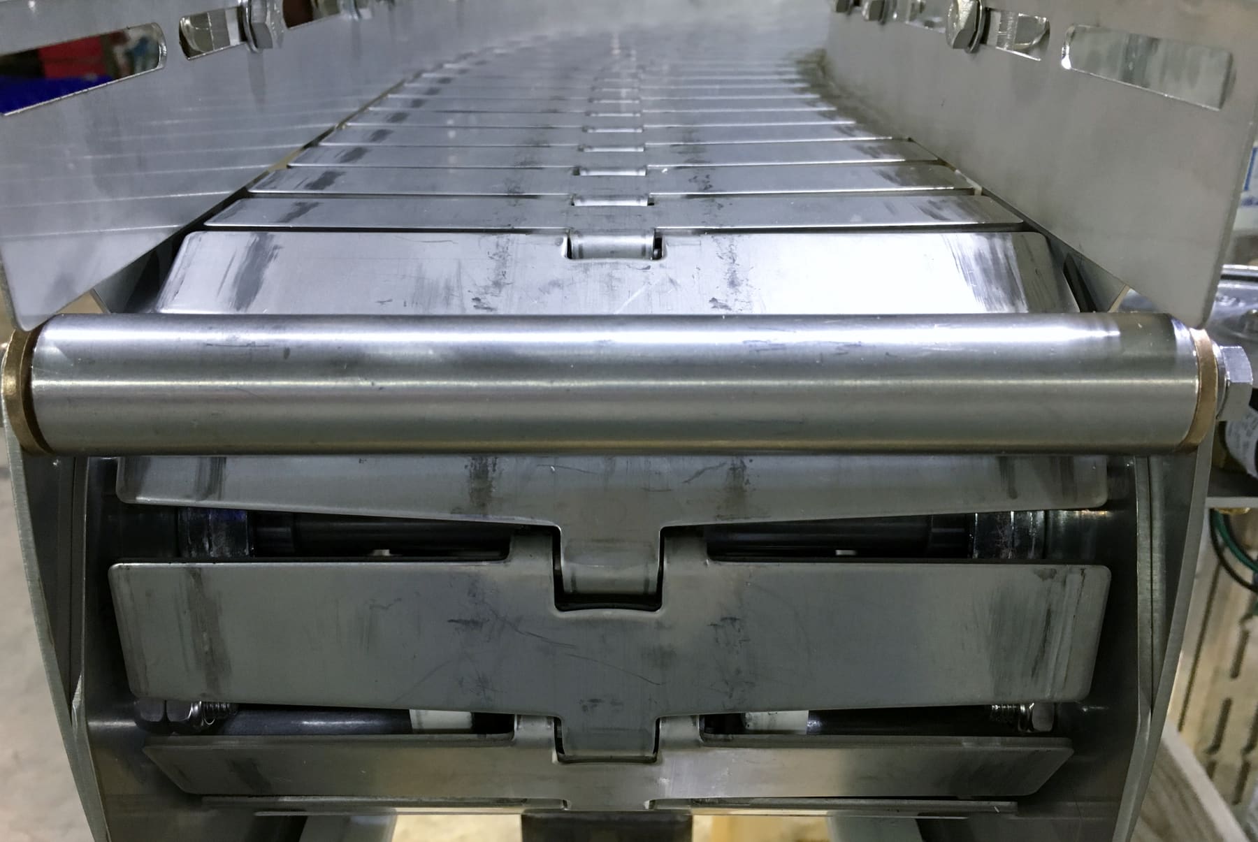 A stainless steel conveyor with drainage channel